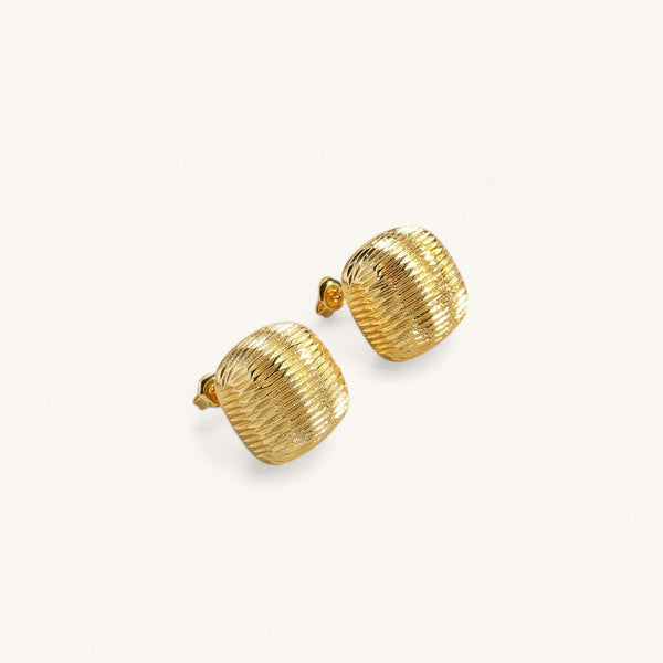 Les Boucles d’Oreilles Bouton